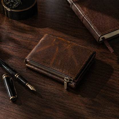 Leather Zipper Wallet in distressed dark mocha full-grain leather, featuring a robust brass zip and technical hand-stitching.