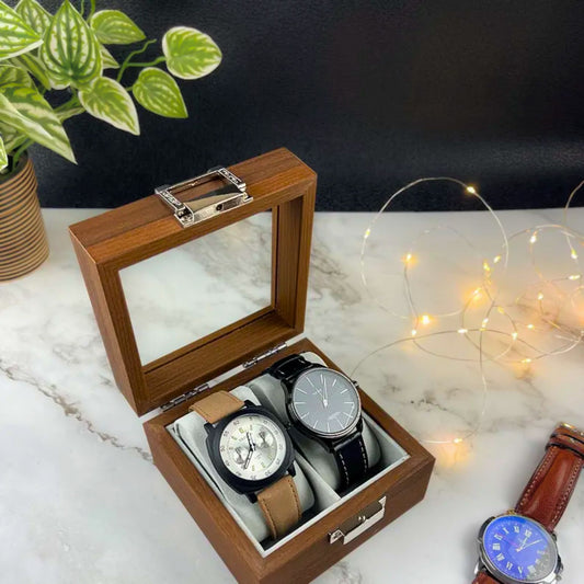 A wooden watch box holding two wristwatches on a marble surface, used to organize and showcase watches beautifully.