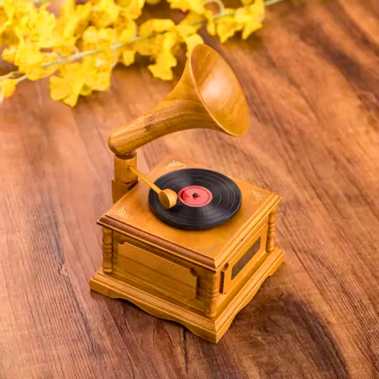 Vintage-style wooden phonograph with a vinyl record on a wooden surface, used as a charming decorative piece or playful gift..
