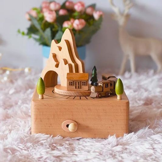 Wooden toy set with a train revolving around a house from the mountains, contains music box, used as a toy and decorative piece.